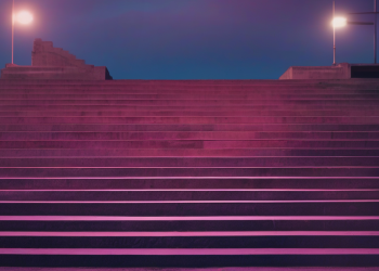 Abstract editorial hero image — navy stadium steps at twilight bathed in magenta rim-light, weathered concrete and a silhouetted trophy lift far in the distance