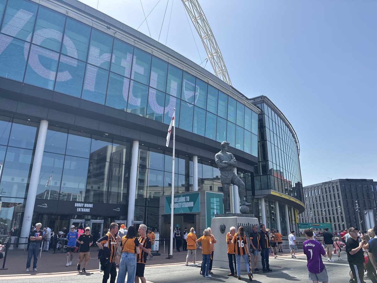 Hull City supporters arriving at Wembley, Bobby Moore statue in the foreground